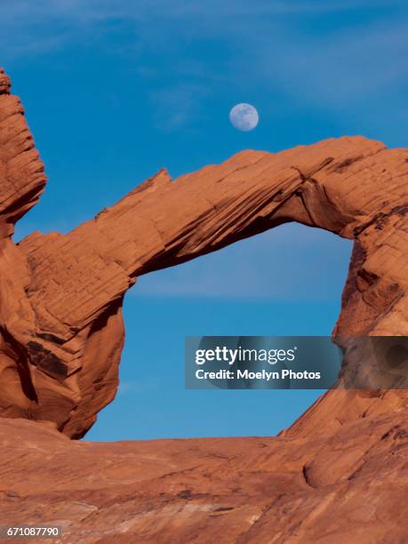 moon over natural arch-valley of fire - telephoto lens stock pictures, royalty-free photos & images