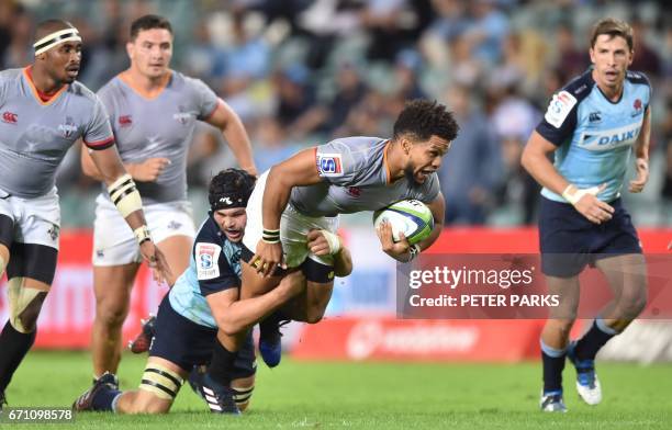 Southern Kings player Burton Klaasen is tacked by Micheal Wells of the Waratahs during the Super15 rugby match between Waratahs and South Africa's...