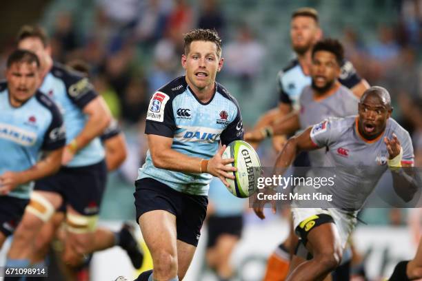 Bernard Foley of the Waratahs runs with the ball during the round nine Super Rugby match between the Waratahs and the Kings at Allianz Stadium on...