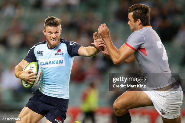 Rob Horne of the Waratahs puts a fend on Nicolaas Hanekom of the Kings during the round nine Super Rugby match between the Waratahs and the Kings at...