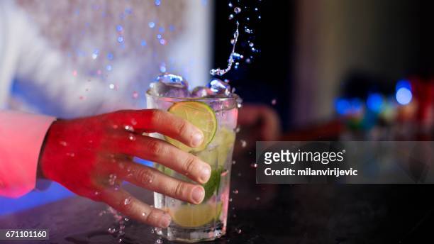 bartender holding mojito - barman tequila stock pictures, royalty-free photos & images