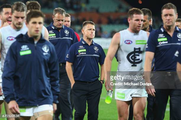 Blues head coach Brendon Bolton looks dejected as Marc Murphy of the Blues leads the team off after defeat during the round five AFL match between...