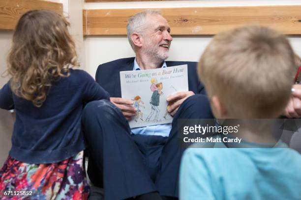 Labour party leader Jeremy Corbyn reads the book 'We're Going on a Bear Hunt' to children at a visit to Brentry Children's Centre, on April 21, 2017...