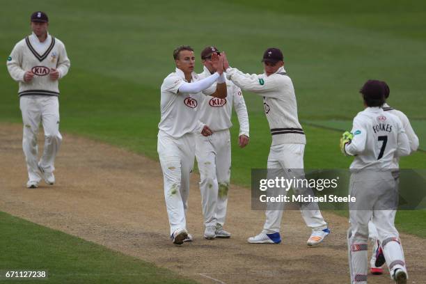 Tom Curran of Surrey celebrates capturing the wicket of Jonathan Trott of Warwickshire during day one of the Specsavers County Championship Division...