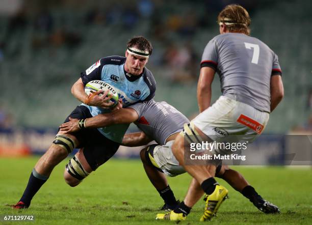 David McDuling of the Waratahs is tackled during the round nine Super Rugby match between the Waratahs and the Kings at Allianz Stadium on April 21,...
