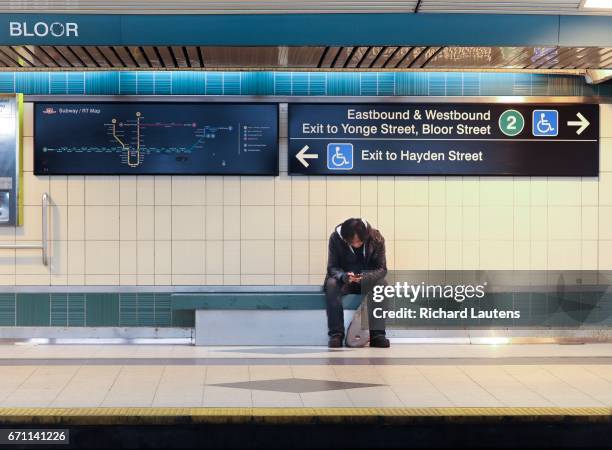 Man sits and waits for the southbound train at the Bloor/Yonge subway station. The TTC has managed to drastically reduce subway delays with the total...