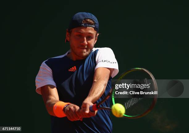 Lucas Pouille of France plays a backhand against Pablo Cuevas of Uruguay in their quarter final round match on day six of the Monte Carlo Rolex...