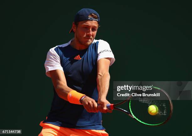 Lucas Pouille of France plays a backhand against Pablo Cuevas of Uruguay in their quarter final round match on day six of the Monte Carlo Rolex...