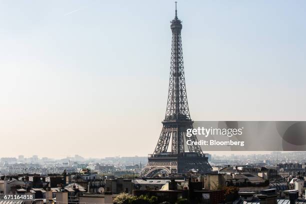 The Eiffel Tower stands as residential and commercial properties sit on the city skyline in Paris, France, on Friday, April 21, 2017. The murder of a...