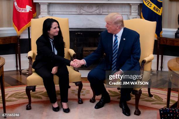 President Donald Trump shakes hands with Aya Hijazi, an Egyptian-American aid worker at the White House in Washington, DC, April 21, 2017. Hijazi was...