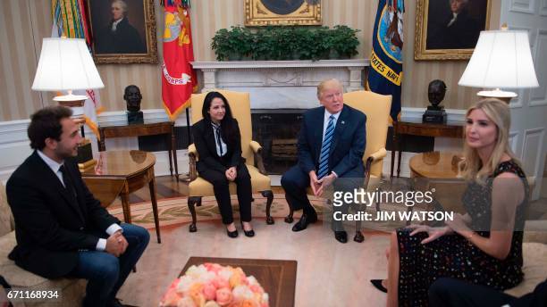 President Donald Trump meets with Aya Hijazi, an Egyptian-American aid worker at the White House in Washington, DC, April 21, 2017 as her brother...
