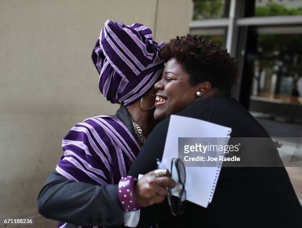 Dorothy Bendross-Mindingall hugs Valencia Gunder as they react while holding a press conference to discuss Sen. Frank Artiles that he had resigned...