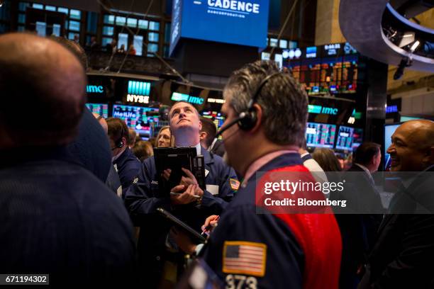 Traders work on the floor of the New York Stock Exchange in New York, U.S., on Friday, April 21, 2017. U.S. Stocks fluctuated, while Treasuries...