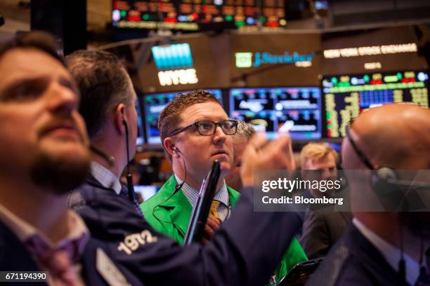 Traders work on the floor of the New York Stock Exchange in New York, U.S., on Friday, April 21, 2017. U.S. Stocks fluctuated, while Treasuries...