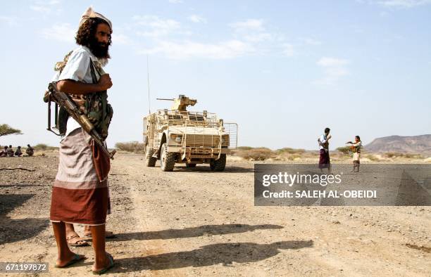 Yemeni fighter loyal to the Saudi-backed Yemeni president stands at a position which was taken from Shiite-Huthi rebels in a mountainous region...