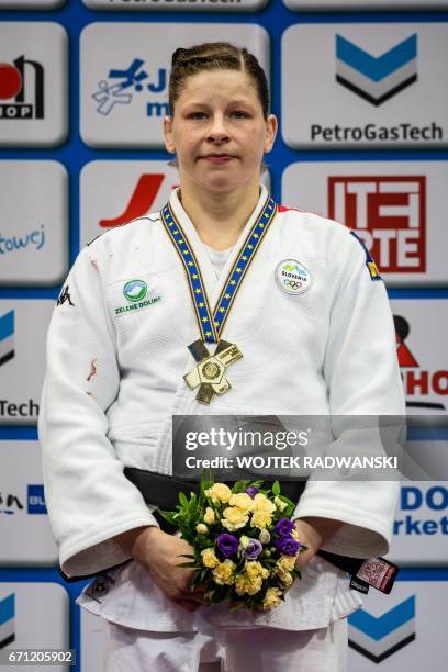 Tina Trstenjak from Slovenia with gold on the podium after women under 63kg competition of European Judo Championship in Warsaw, April 21, 2017. /...