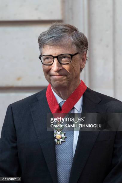 Microsoft co-founder Bill Gates poses after receiving the Commander of the Legion of Honour title at the Elysee Palace in Paris on April 21, 2017. -...