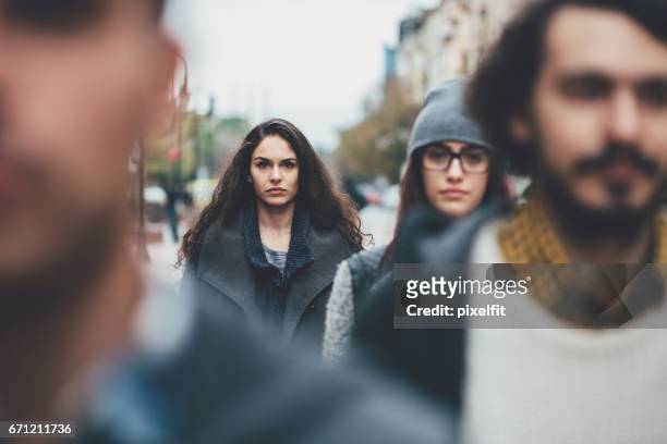 serious woman in the crowd - crowd of people walking stock pictures, royalty-free photos & images