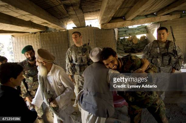 Soldiers with the 173rd division, Battle company: Captain Dan Kearney, left, and Sergeant Mike Nestell, right, meet with village elders Zawar Khan...