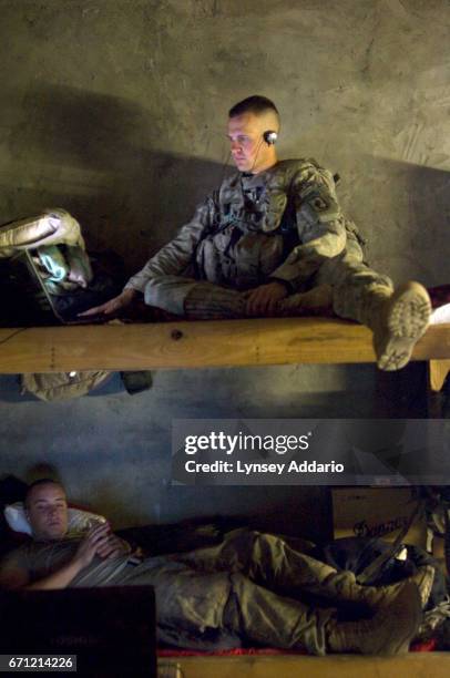 Nikolai Polikolsky top bunk, a gunner, of Riverside, California, listens to music and looks at pictures of his girlfriend. Bottom bunk: PFC rocky...