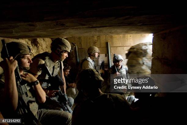 Soldiers with the 173rd division and Afghan workers on the base moments before a mortar fired by the Taliban lands about 20 feet from the opening of...