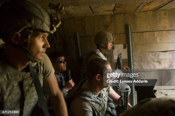 Soldiers with the 173rd division and Afghan workers on the base hide in a bunker at the KOP forward operating base as the Taliban fires mortars at...