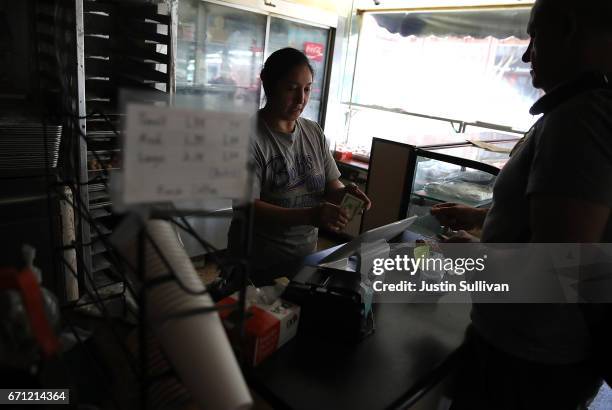 Worker sells donuts in the dark during a citywide power outage on April 21, 2017 in San Francisco, California. Nearly 100,000 Pacific Gas and...