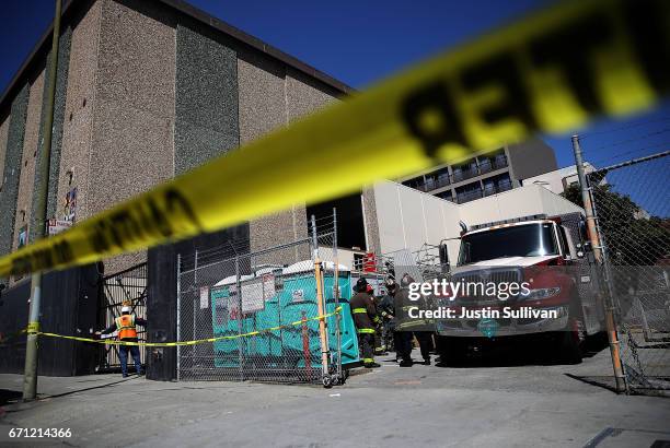 San Francisco fire department crews stand outside of an electric substation where a fire occured and might have caused a citywide power outage on...