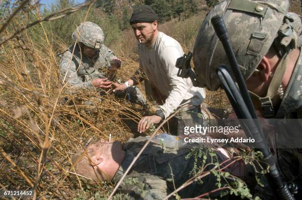 American soldiers with the 173rd battle company, on a battalion-wide mission in the korengal valley. Sergeant Kevin Rice reaches over to reassure...