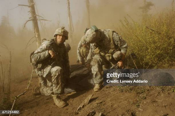 Soldiers with the 173rd battle company, on a battalion-wide mission in the Korengal valley Left, Sgt. John Clinard, and right, Jay Liske, and other...