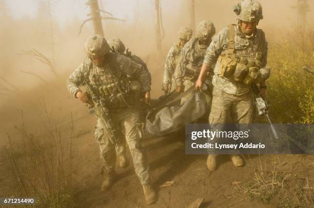 Soldiers with the 173rd battle company, on a battalion-wide mission in the Korengal valley Left, Sgt. John Clinard, and right, Jay Liske, and other...