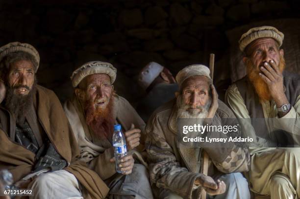 Afghan elders from a 'hostile' village in the Korengal Valley listen to American commanders explain why they had to attack their village with heavy...