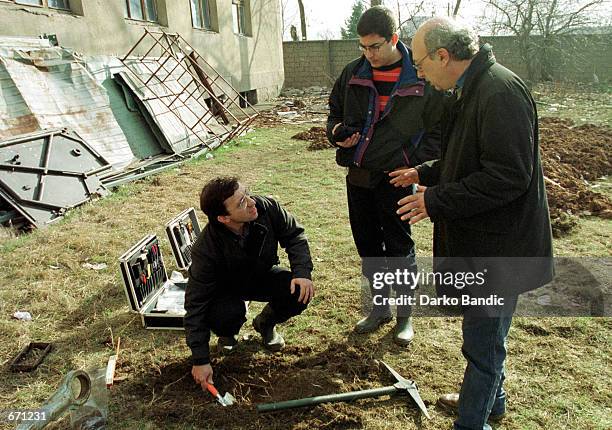 Experts from the Greek "Helenic Atomic Energy Commission" collect soil samples for radioactivity analysis January 11, 2001 at the Greek NATO base in...