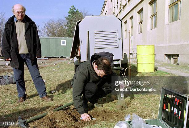 Experts from the Greek "Helenic Atomic Energy Commission" collect soil samples for radioactivity analysis January 11, 2001 at the Greek NATO base in...