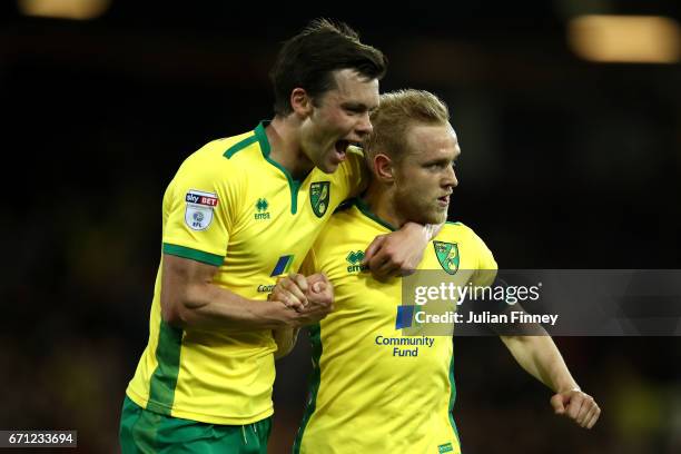 Alex Pritchard of Norwich City celebrates with Jonathan Howson after David Stockdale of Brighton and Hove Albion scores his second own goal during...