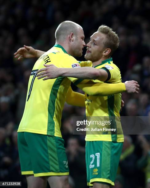 Alex Pritchard of Norwich City celebrates with Steven Naismith after David Stockdale of Brighton and Hove Albion scores his second own goal during...