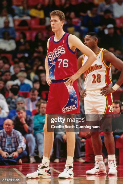 Shawn Bradley of the Philadelphia 76ers stands against the Atlanta Hawks during a game played circa 1990 at the Omni in Atlanta, Georgia. NOTE TO...