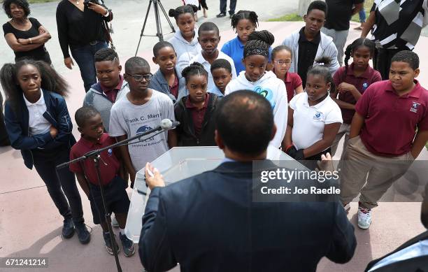 Pastor Alphonso Jackson, from the Second Baptist Church, explains to children from an After School Care Program the reason State Senator Frank...