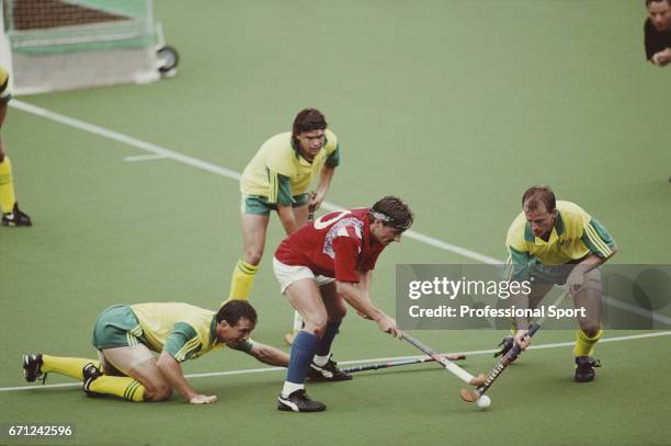 View of play between Great Britain and Australia, with Great Britain player Russell Garcia tackling an Australian player for the ball, in the group A...