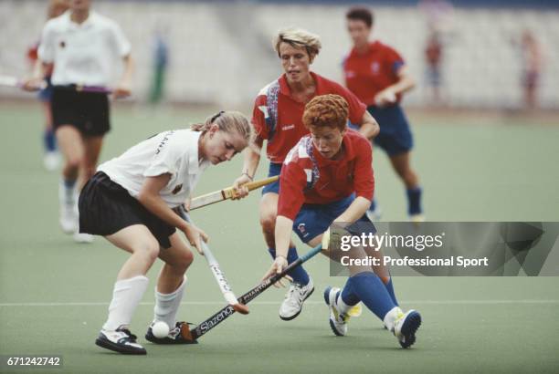 View of play between Germany and Great Britain, with Jane Sixsmith of Great Britain tackling a German player for the ball, in the semifinals of the...