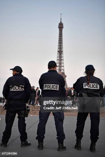 Police officers secure the Place du Trocadero in front of the Eiffel Tower the day after a gunman opened fire on police officers on the Champs...