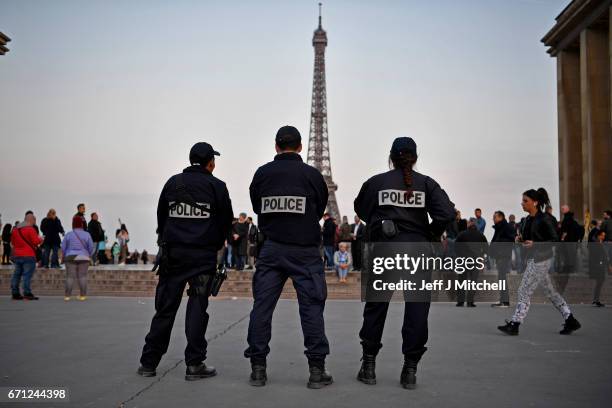 Police officers secure the Place du Trocadero in front of the Eiffel Tower the day after a gunman opened fire on police officers on the Champs...