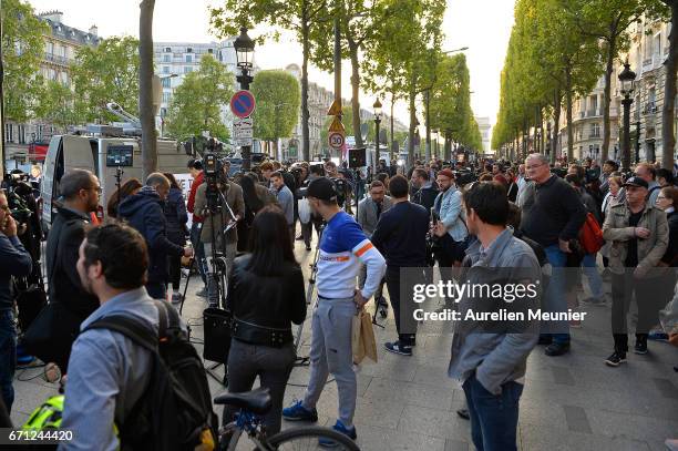 General view as people and the media gather on the Champs Elysees the day after a gunman opened fire on police officers on April 21, 2017 in Paris,...