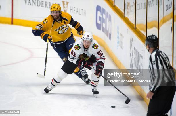 Brian Campbell of the Chicago Blackhawks skates against James Neal of the Nashville Predators in Game Three of the Western Conference First Round...