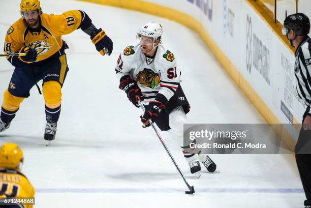 Brian Campbell of the Chicago Blackhawks skates against James Neal of the Nashville Predators in Game Three of the Western Conference First Round...