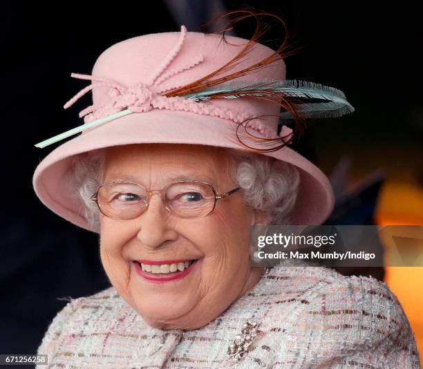 Queen Elizabeth II, who celebrates her 91st birthday today, watches the racing as she attends the Dubai Duty Free Spring Trials Meeting at Newbury...