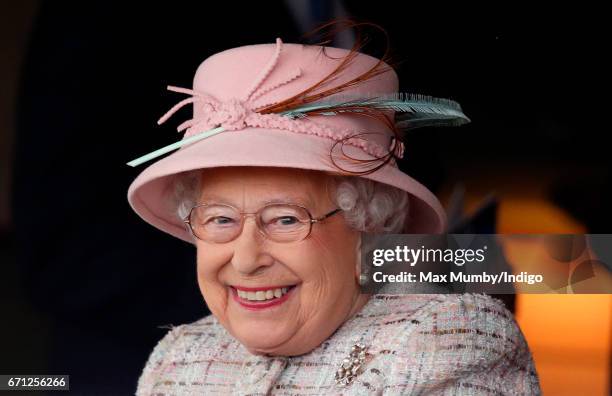 Queen Elizabeth II, who celebrates her 91st birthday today, watches the racing as she attends the Dubai Duty Free Spring Trials Meeting at Newbury...