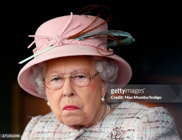 Queen Elizabeth II, who celebrates her 91st birthday today, watches the racing as she attends the Dubai Duty Free Spring Trials Meeting at Newbury...
