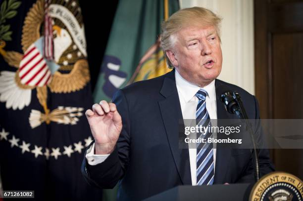 President Donald Trump speaks before signing an executive order in Washington, D.C., U.S., on Friday, April 21, 2017. The tax code became too...