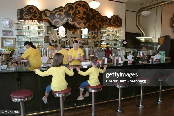 Girls sat at the bar in The Palace Ice Cream and Sandwich Shop.